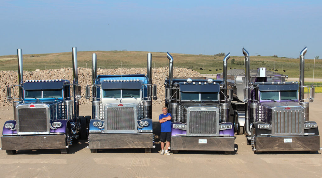 Lorne Pictured with Four Peterbilt Daycabs & One Belly Dump Trailer