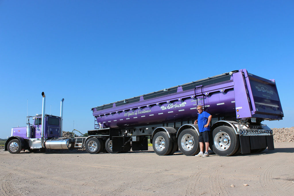 Lorne Pictured with Purple Peterbilt & Tridem Trailer Highlighting 40 Years of Excellence-Rear