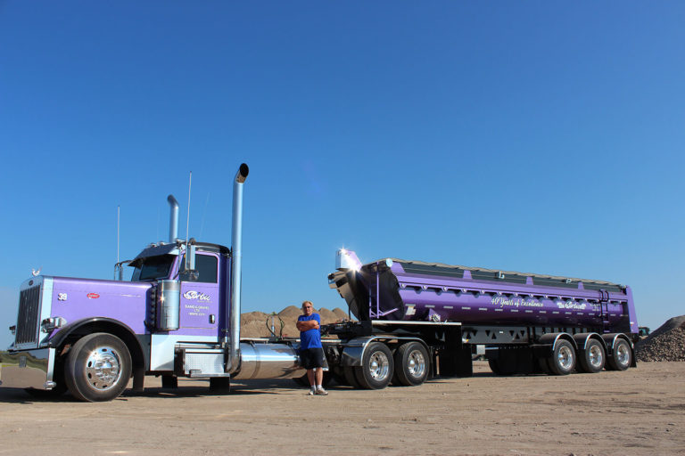 Lorne Pictured with Purple Peterbilt & Tridem Trailer Highlighting 40 Years of Excellence-Side