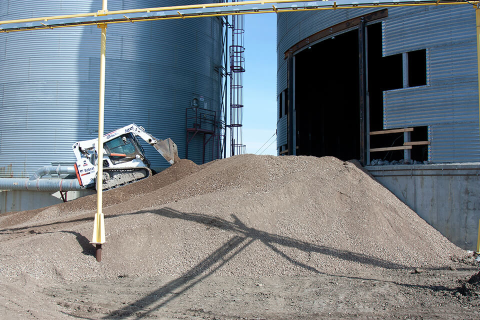 We used a skid steer to build a ramp to the grain bin.
