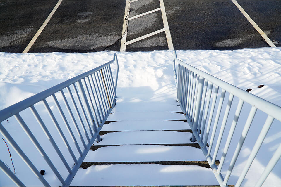 Snow covered stairs are safety hazards that need to be identified.