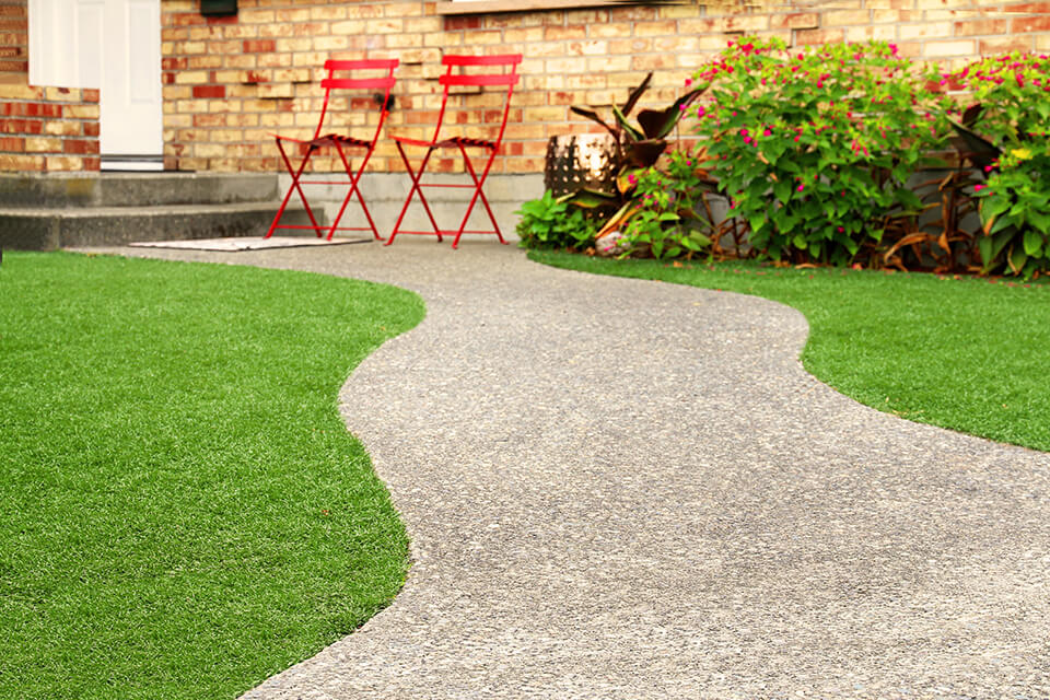 Artificial grass and gravel walkway.