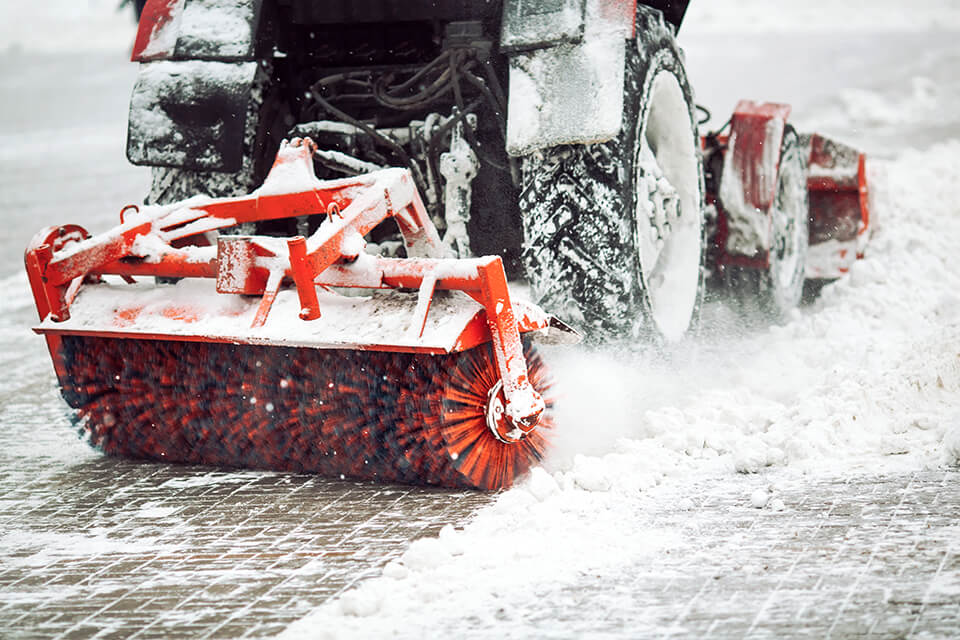 Snow brush machine clearing snow.