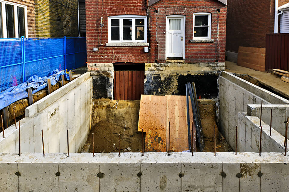 Basement excavation adjacent to existing house.