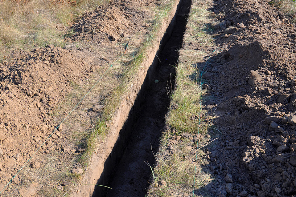 A trench ready to be backfilled with fill dirt or PG&E sand.