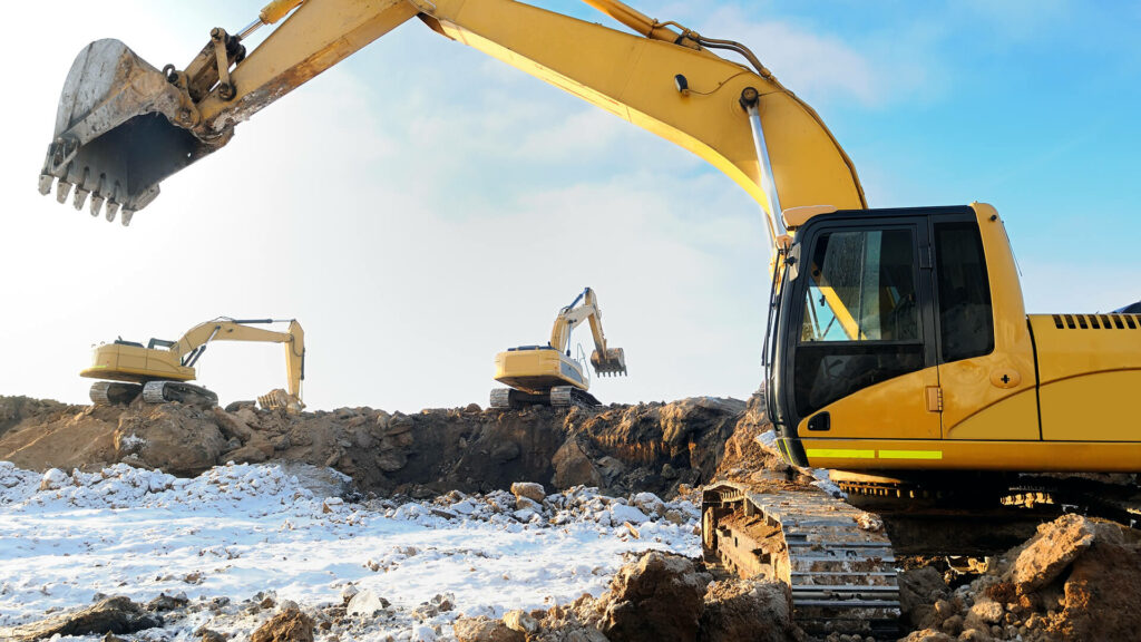 An excavator digging in the snow..