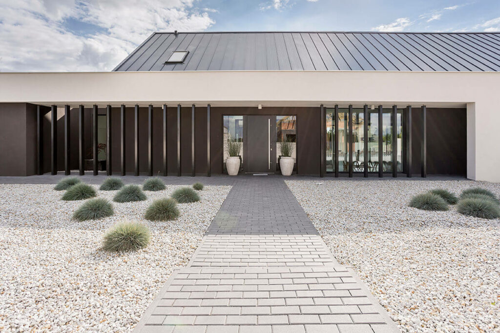 Desertlike gravel garden in front of a modern house.