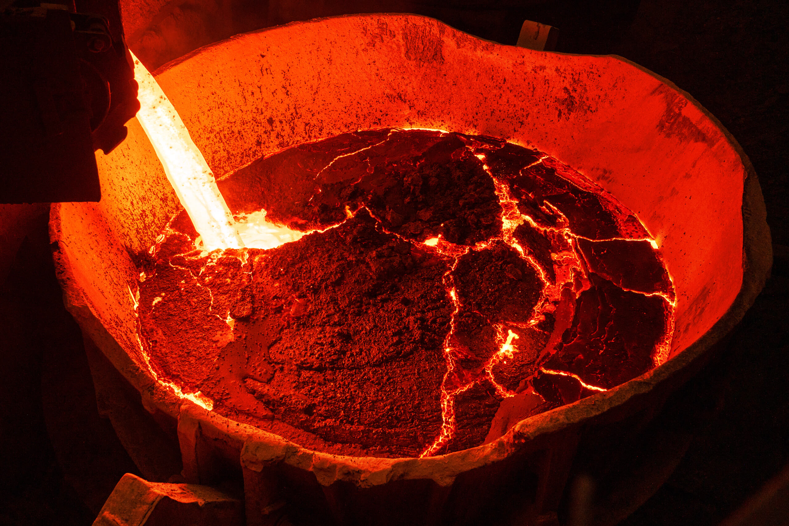 Molten slag fresh from the steelmaking process is collected in large ladles.