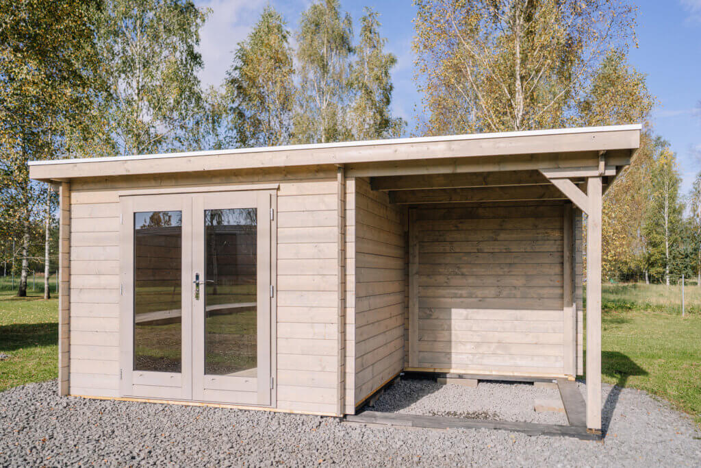Wood shed on a gravel pad.